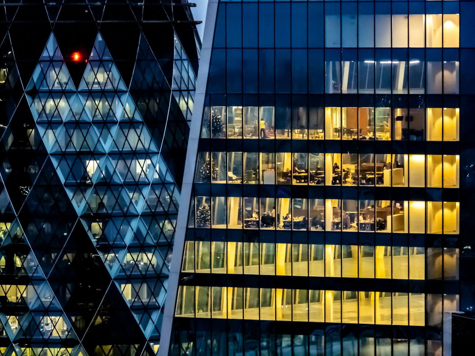 Glass office towers lit at dusk
