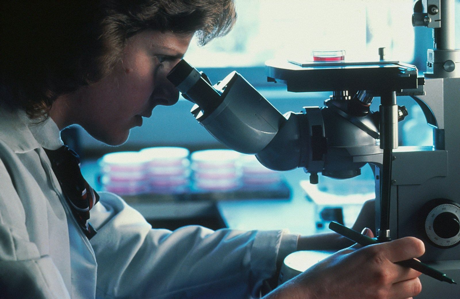 A scientist using a microscope
